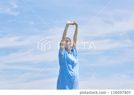 A woman stretching outdoors A woman stretching outdoors 116097805