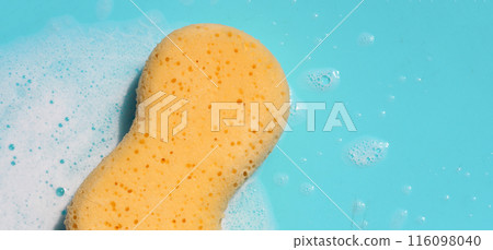 Yellow sponge with bubbles on blue background 116098040