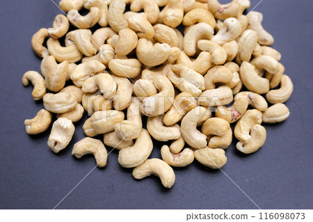 Cashew nuts on dark background. Cashew nuts on dark background. 116098073