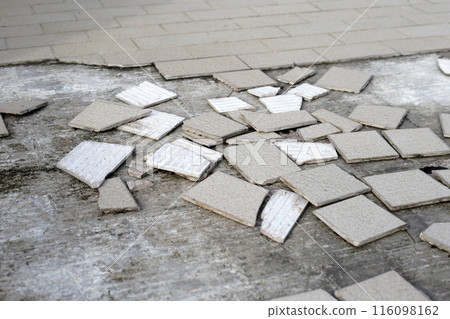 Cracked brown tiles on cement floor Cracked brown tiles on cement floor 116098162
