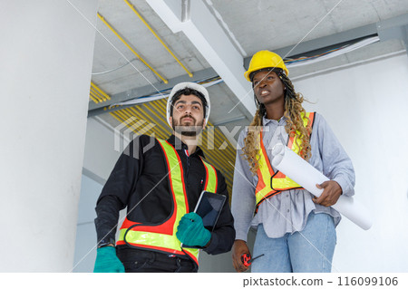 Construction civil engineer man and woman African American using tablet check quality of work Construction civil engineer man and woman African American using tablet check quality of work 116099106