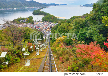 Amanohashidate seen from the monorail at Amanohashidate View Land: Hiryu-kan and autumn leaves (Miyazu City, Kyoto Prefecture) 116099449