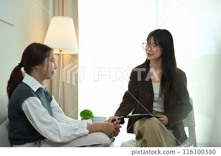 Psychotherapy in eyeglasses talking and giving advice female patient in the clinic. Mental health concept Psychotherapy in eyeglasses talking and giving advice female patient in the clinic. Mental health concept 116100380