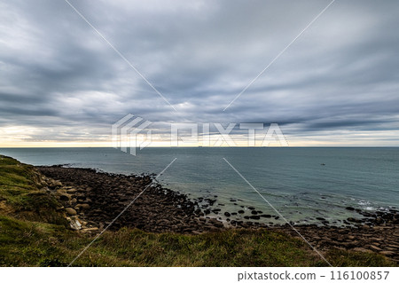 Breathtaking coastal view with cloudy sky, rocky shoreline, and dramatic sea and nature landscapes Breathtaking coastal view with cloudy sky, rocky shoreline, and dramatic sea and nature landscapes 116100857