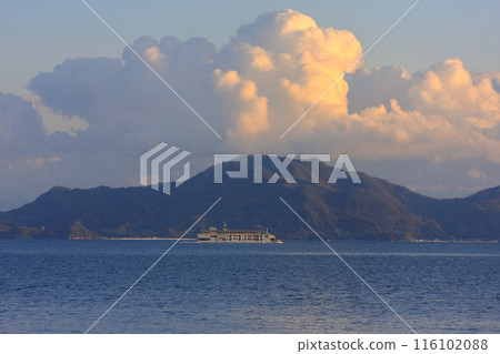 A luxury cruise ship sailing slowly through the Seto Inland Sea 116102088