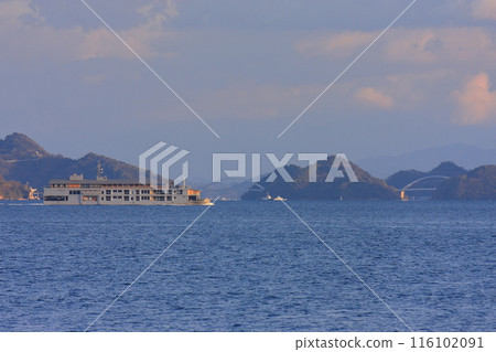 A luxury cruise ship sailing slowly through the Seto Inland Sea A luxury cruise ship sailing slowly through the Seto Inland Sea 116102091