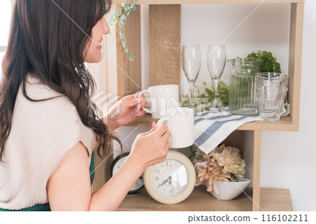 Female staff working part-time at a general store, apparel, interior design, and craft natural shop. 116102211