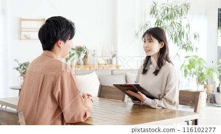 Woman interviewing a man 116102277