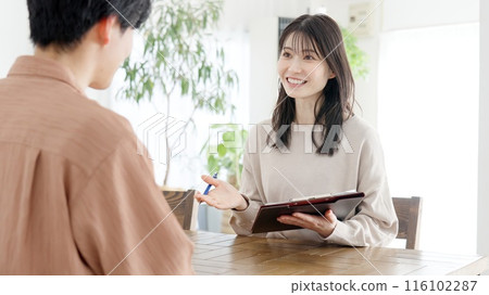 Woman interviewing a man 116102287