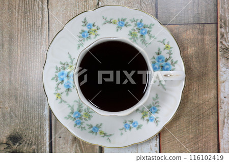 Coffee in a floral cup Coffee in a floral cup 116102419