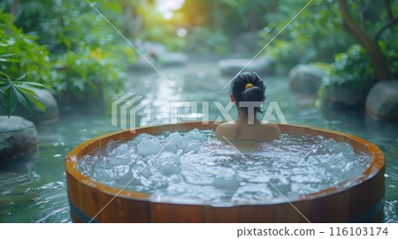 Woman in Ice Bath Near River Spa Woman in Ice Bath Near River Spa 116103174