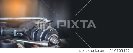 Banner Mechanic tools engineering equipment car auto repair shop with copy space. Blurred background mechanical service. Banner Heavy screw grungy rusted dirty object black background with copy space 116103392