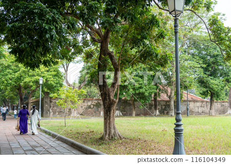 People dressed in formal attire walk around the Hue Imperial Palace, a World Heritage Site that preserves the splendor of Vietnam's last dynasty, on National Day. 116104349