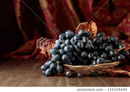 Blue grapes on an old wooden table. Blue grapes on an old wooden table. 116104449