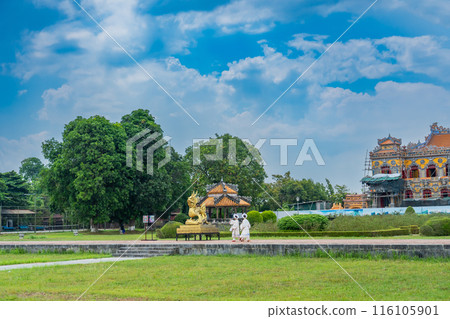 A woman dressed in formal attire walks in front of a golden dragon at the Hue Imperial Palace, a World Heritage site that preserves the splendor of Vietnam's last dynasty, on National Day. A woman dressed in formal attire walks in front of a golden dragon at the Hue Imperial Palace, a World Heritage site that preserves the splendor of Vietnam's last dynasty, on National Day. 116105901