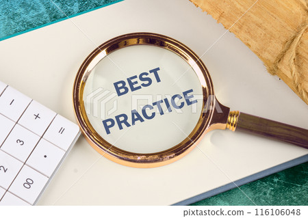 Business concept. Words BEST PRACTICE appeared through a magnifying glass in a notebook, close-up. View from above Business concept. Words BEST PRACTICE appeared through a magnifying glass in a notebook, close-up. View from above 116106048