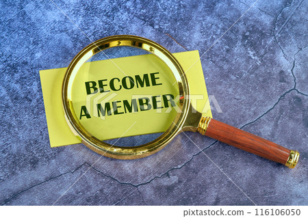 The inscription BECOME A MEMBER appeared through a magnifying glass on yellow paper on an abstract background The inscription BECOME A MEMBER appeared through a magnifying glass on yellow paper on an abstract background 116106050