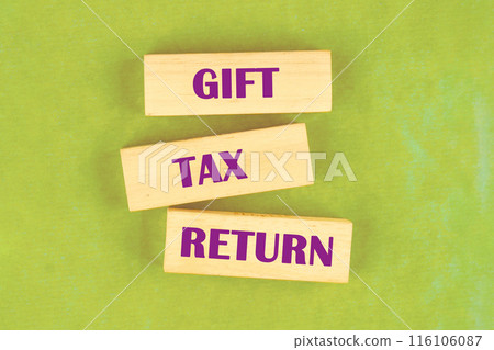 Text GIFT TAX RETURN on wooden blocks on a bright greenish background Text GIFT TAX RETURN on wooden blocks on a bright greenish background 116106087