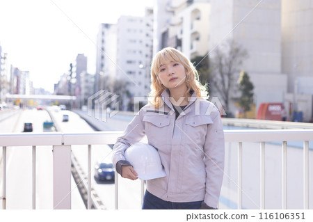 Business Woman in work clothes working at a construction site Business Woman in work clothes working at a construction site 116106351