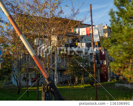 Clothes are dried on a line. Colorful houses. Urban environment. Beautiful sunny day in the city. Yard in Batumi. Aesthetics of life in the south 116106991