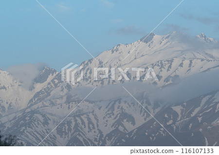 Snowy mountains covered in clouds, Northern Alps Snowy mountains covered in clouds, Northern Alps 116107133