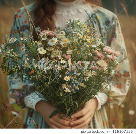 A young girl presents a bouquet of wildflowers A young girl presents a bouquet of wildflowers 116107136