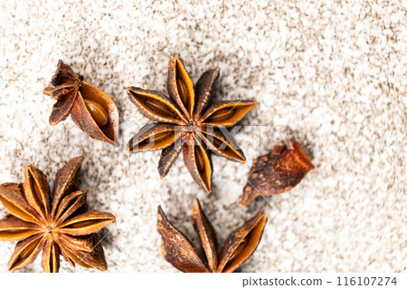 Spice star anise closeup on gray stone background Spice star anise closeup on gray stone background 116107274
