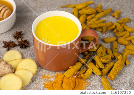 Natural Ayurvedic drink golden milk with turmeric and spices in a mug 116107290