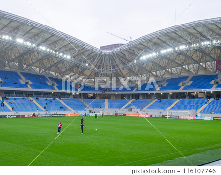 At the stadium before the match. Half empty stadium. The fans haven't arrived yet. Waiting for a football match. Georgian championship. People fill the stands. editorial content At the stadium before the match. Half empty stadium. The fans haven't arrived yet. Waiting for a football match. Georgian championship. People fill the stands. editorial content 116107746