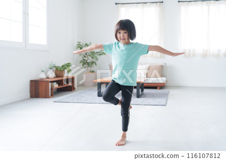 Child's whole body standing on one leg at home (exercise, sports, stretching) 116107812
