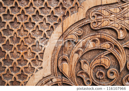 detail of oriental Islamic pattern Uzbek traditional ornament on wooden carved door in Tashkent close-up 116107966