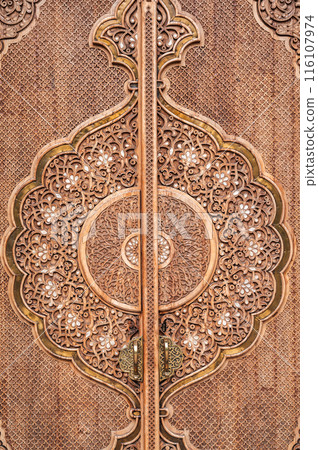oriental pattern Uzbek traditional ornament on wooden carved door in Museum of Political Repression in Tashkent in Uzbekistan close-up 116107974