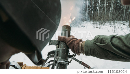 Mortar Shooting Explosions Forest. Close-up View On Re-enactors Dressed As American Infantry Soldiers Fire From Mortar. Usa Army Soldiers Of World War Ii. Reconstruction Defense Battles. Heroes Of War 116108024