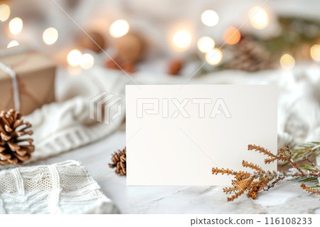 An inviting blank card with soft knitted fabric and natural pinecones 116108233