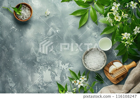 A spa display with bath salts, green leaves, and white flowers 116108247