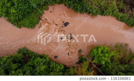 Close-up aerial view of the mighty Mekong River shows its muddy waterways flowing hard and fast during the rainy season. Close-up aerial view of the mighty Mekong River shows its muddy waterways flowing hard and fast during the rainy season. 116108861