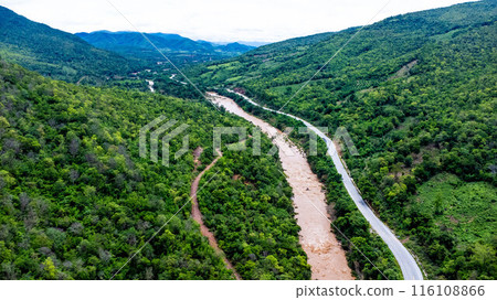 Aerial view of the mighty Mekong River meandering in the morning during the rainy season against the lush green mountains. Aerial view of the mighty Mekong River meandering in the morning during the rainy season against the lush green mountains. 116108866