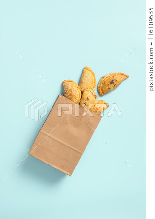 Traditional Samsa Pastries from Central Asia in Delivery Paper Bag, flat lay, copy space. Traditional Samsa Pastries from Central Asia in Delivery Paper Bag, flat lay, copy space. 116109535