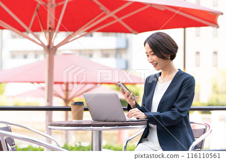 A woman working at an open cafe 116110561