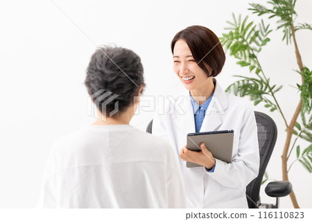 Doctor and patient interviewing face-to-face Doctor and patient interviewing face-to-face 116110823