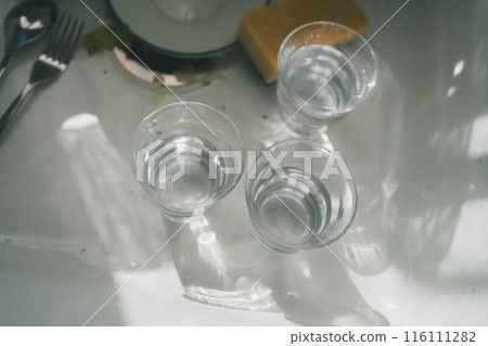 Glasses left in the kitchen sink 116111282