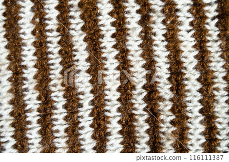 Handmade knitted fabric brown and white wool background texture 116111387