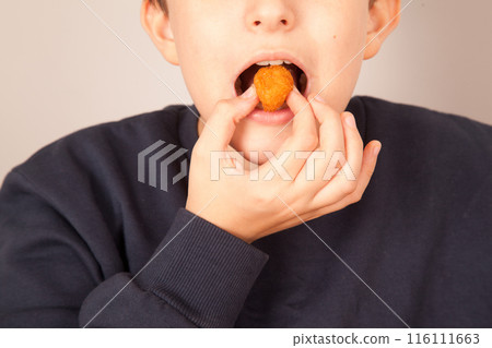 Caucasian man eating fried chicken balls, American fast food culture, cooked chicken pieces Caucasian man eating fried chicken balls, American fast food culture, cooked chicken pieces 116111663