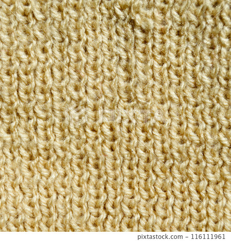 Handmade knitted fabric yellow and beige wool background texture 116111961