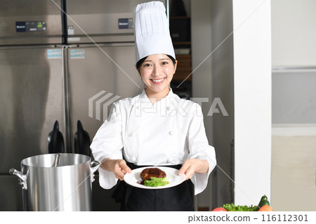 Young asian female chef serving meat dishes Young asian female chef serving meat dishes 116112301