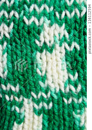 Handmade knitted fabric green and white wool background texture 116112594
