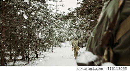 American Infantry Soldier Going Through Forest Road In Cold Winter Day. Group of Usa Soldiers Marching In Country Road. Usa Army Soldiers Of World War Ii. Heroes Of War 116113065