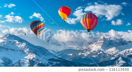 Three hot air balloons soar over snowcapped mountains 116113930