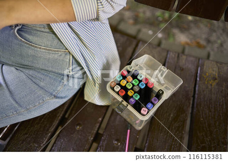 a young artist draws a sketch of a window on the streets of the city a young artist draws a sketch of a window on the streets of the city 116115381