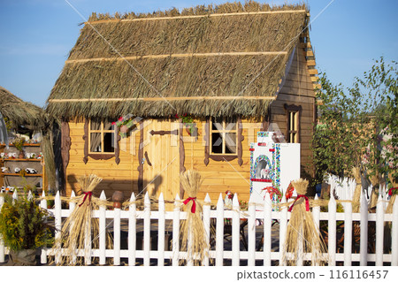 A village Ukrainian hut with a straw roof. A village Ukrainian hut with a straw roof. 116116457